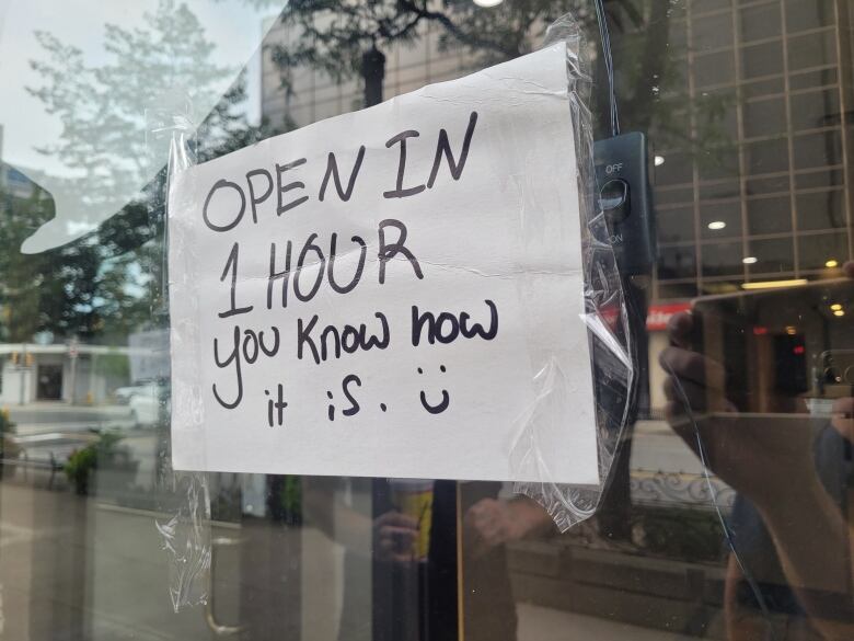 A cardboard sign in the window of a store