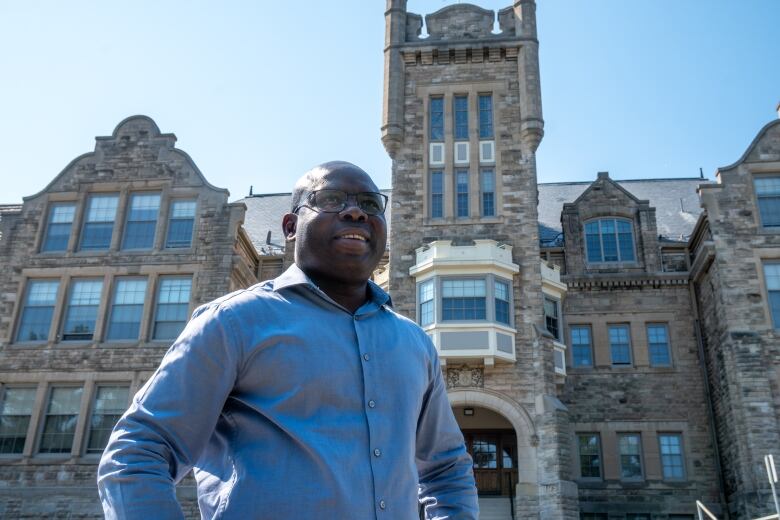 A man stands outside a building.