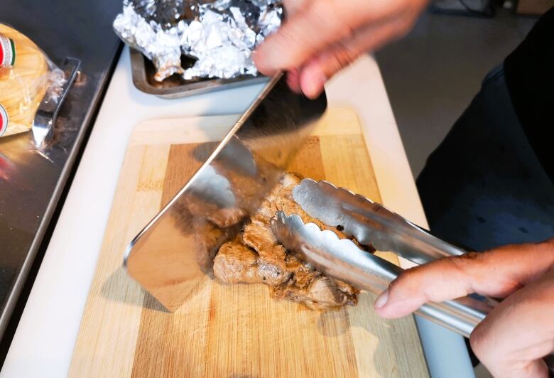 Chef Fernando Toro cuts up beef and preps ingredients for his carne asada tacos