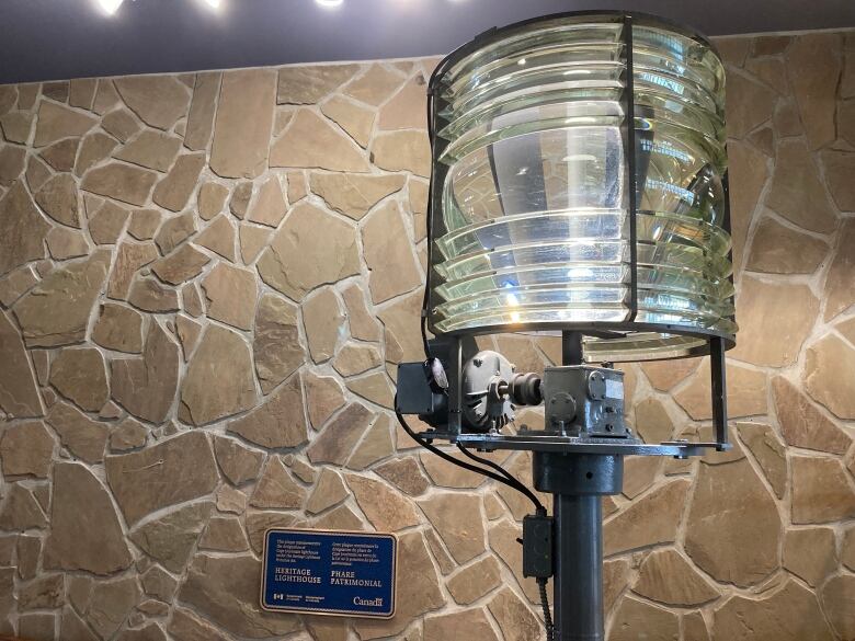 A fresnel lens in front of a stone wall