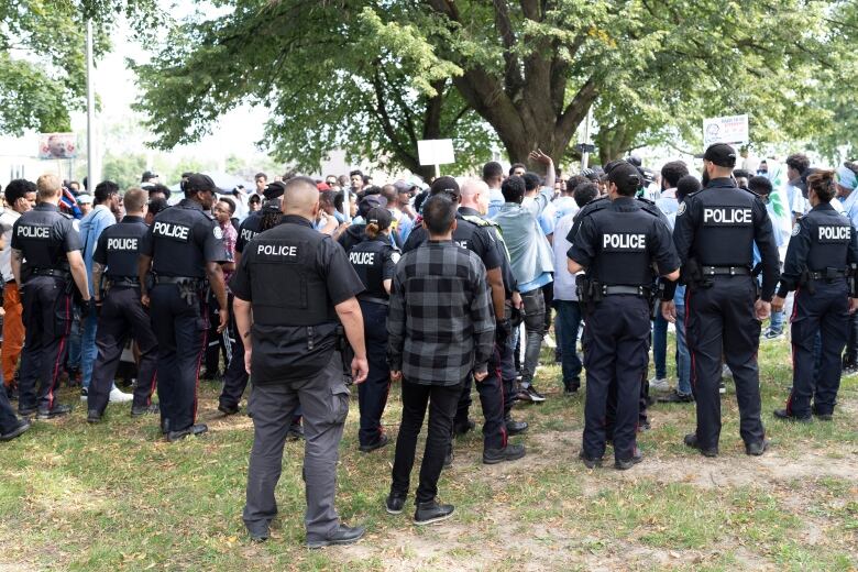 Toronto Police work the scene of a protest that turned violent in Earlscourt Park in Toronto, on Saturday, Aug. 5 2023.