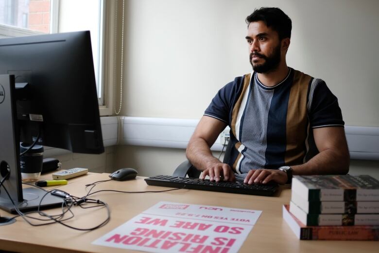 A man works at a computer.