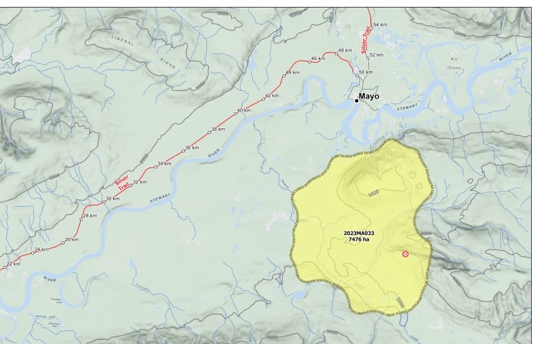 A map shows the town of Mayo, Yukon, and an area to the south coloured yellow indicating the size and location of a wildfire.