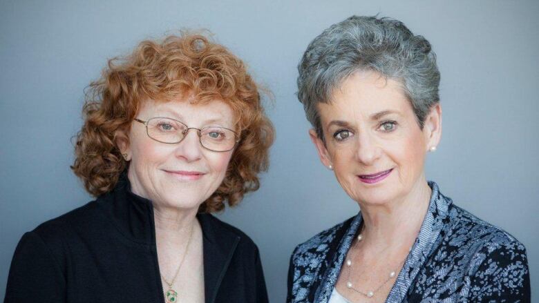 Two white women, one with shoulder-length brown hair and the other with short grey hair, smile for a headshot.