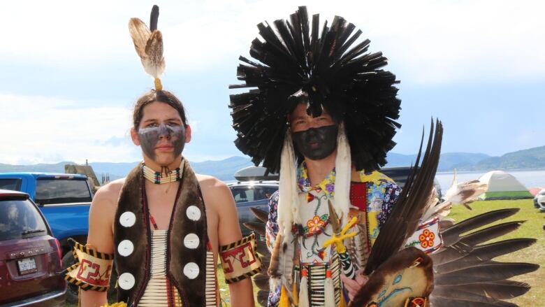 Two people wearing traditional dance outfits.