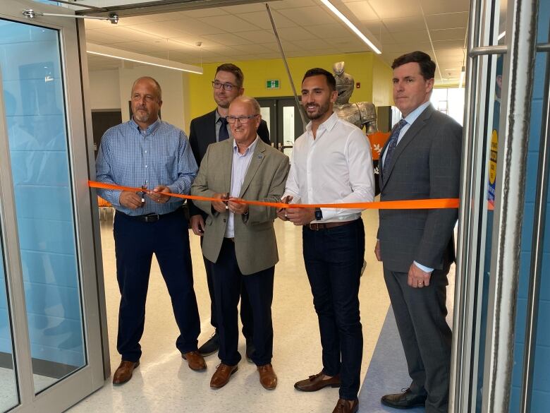 Left to right - Lasalle Elementary School principal Jim Wachnuk, superintendent of business Adam Guilbault, RDSB chair Bob Clement, Education minister Stephen Lecce and director Bruce Bourget take part in a ribbon cutting at the upcoming Lasalle Elementary School in Sudbury, Ont.