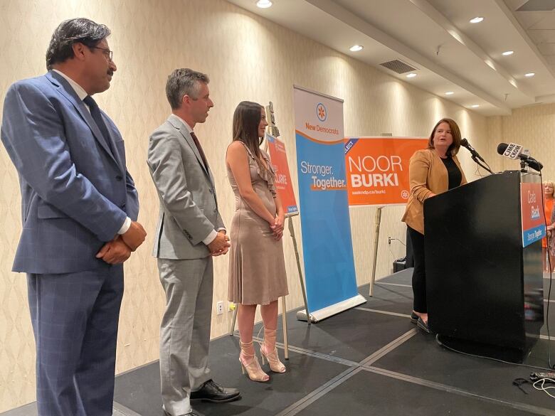 NDP members stand in a row.