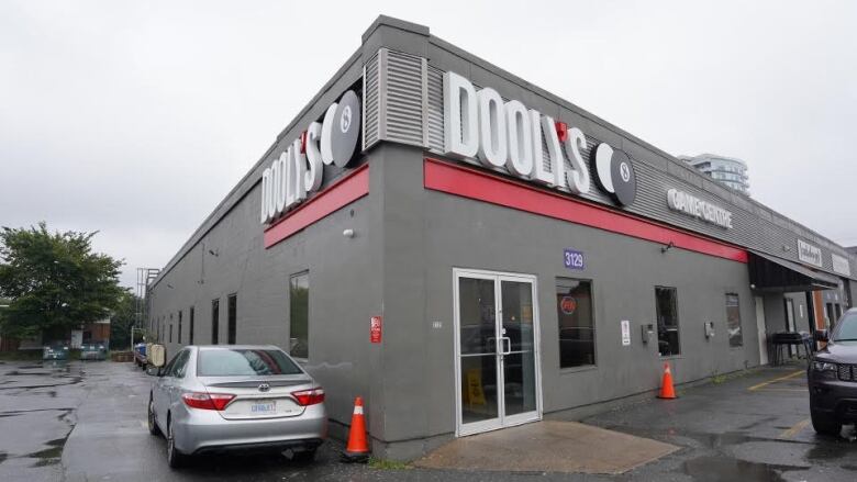 A grey building with a Dooly's sign and 8 ball. 