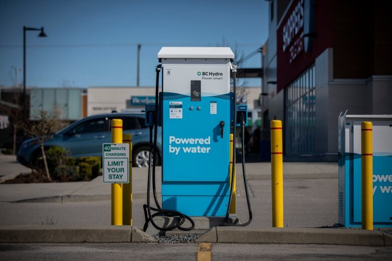 A blue electric vehicle charging station with the words 'Powered by water' and the B.C. Hydro logo.