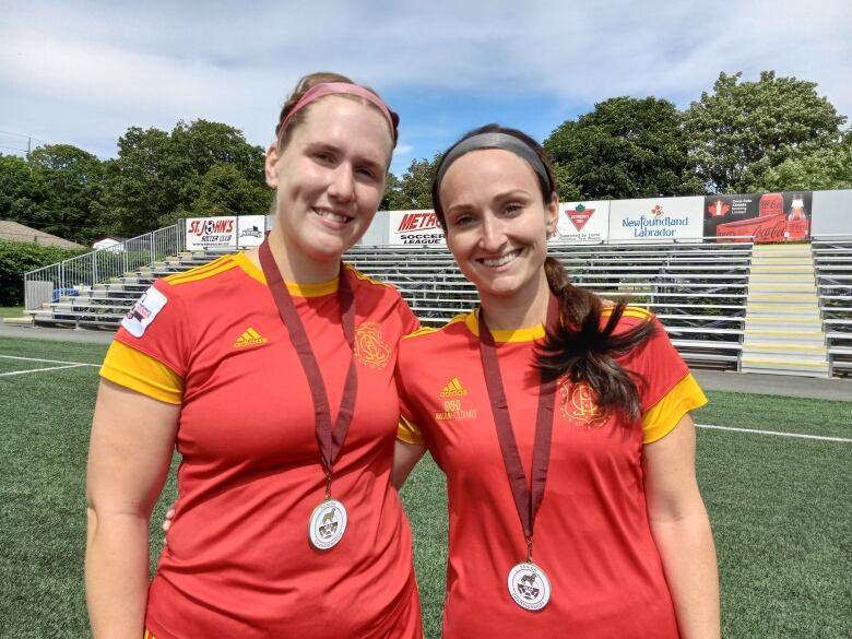 Two women in red soccer uniforms