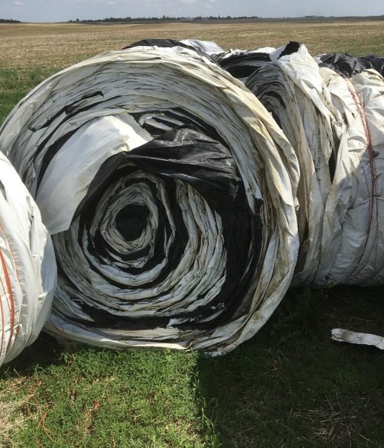 Rolled grain bags ready to be shipped to a recycling facility are visible in the photo.