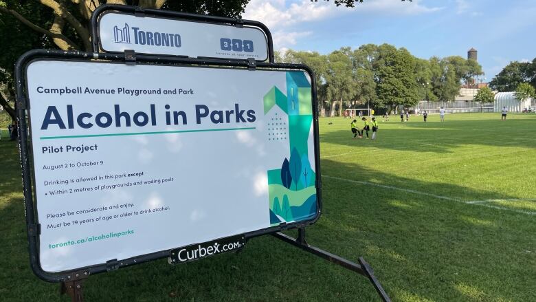 A sign announcing the alcohol in parks pilot project in a Toronto park.