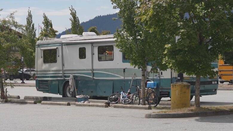 An RV is parked in a parking lot.