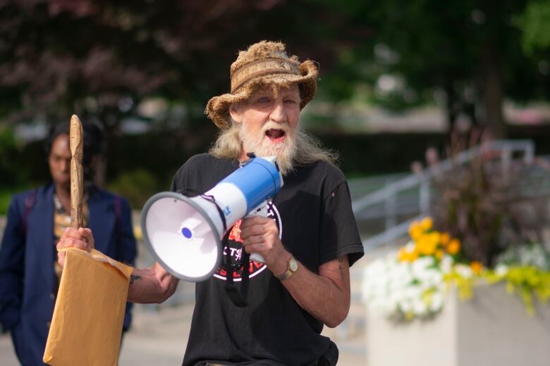 A man standing and talking.