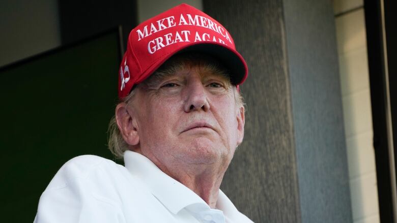 Former President Donald Trump looks over the 18th hole during the final round of the Bedminster Invitational LIV Golf tournament in Bedminster, N.J., Sunday, Aug. 13, 2023. (AP Photo/Seth Wenig)