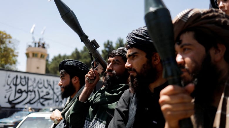 Taliban soldiers celebrate on the second anniversary of the fall of Kabul.