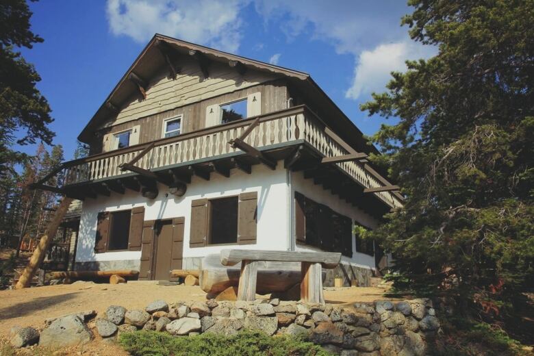 A wooden house on the hill.