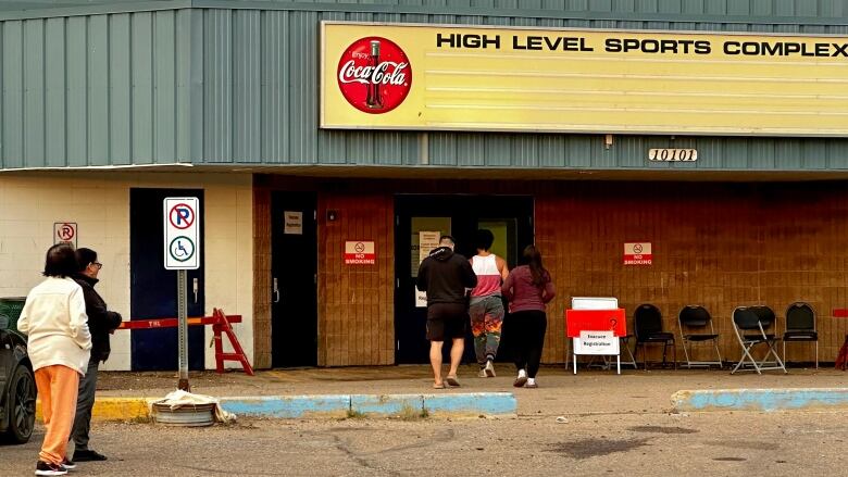 Evacuees from Yellowknife, many of whom have driven all night, head into the evacuation centre in northern Alberta.