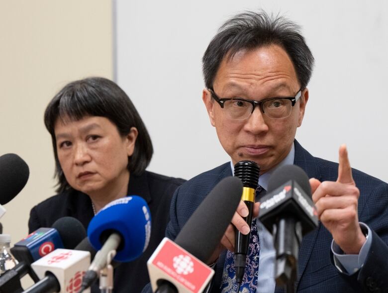 Sen. Yuen Pau Woo denounces RCMP allegations of Chinese government interference in Canada as community organizer May Chiu looks on during a news conference at the Chinese Family Service center, May 5, 2023  in Montreal. 