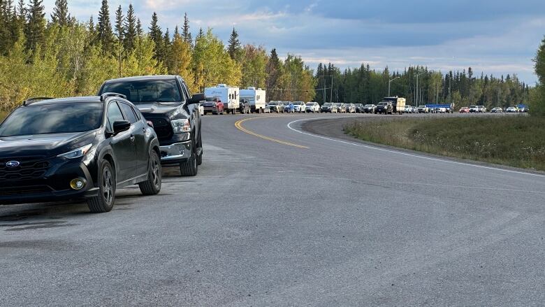 Cars on highway, trees.