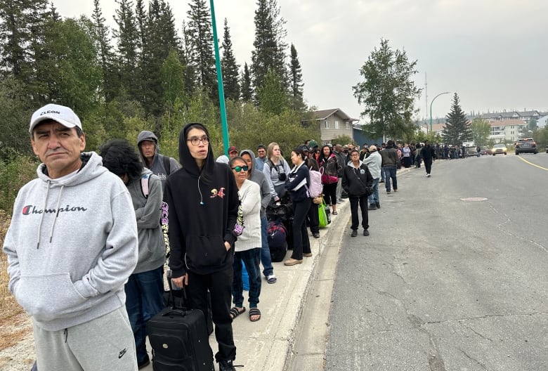 People lining up down street.