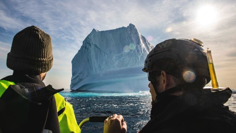 two people looking at an iceberg