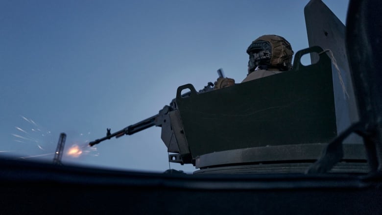 A Ukrainian soldier is seen firing a weapon in Avdiivka, in Ukraine's Donetsk region, on Friday.