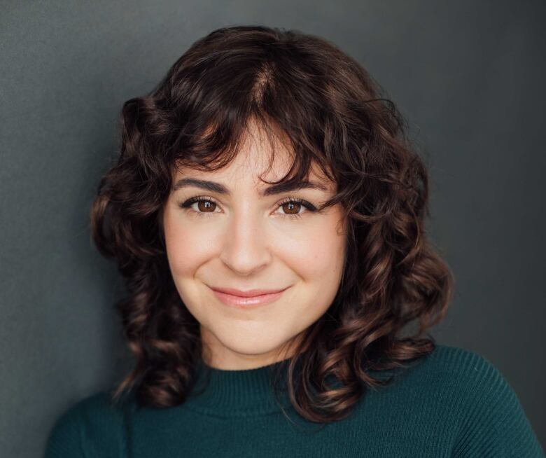 A headshot of an actress against a black background.