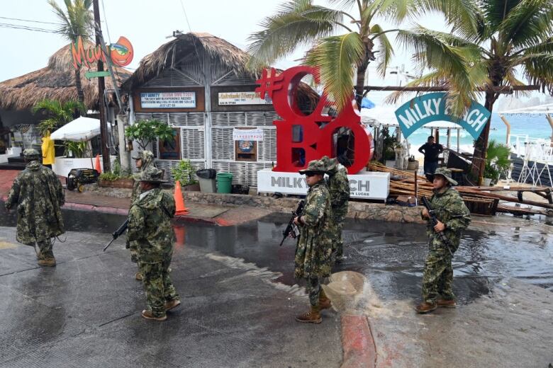 Members of the Mexican Navy patrol a beach before the arrival of a hurricane Hilary. 