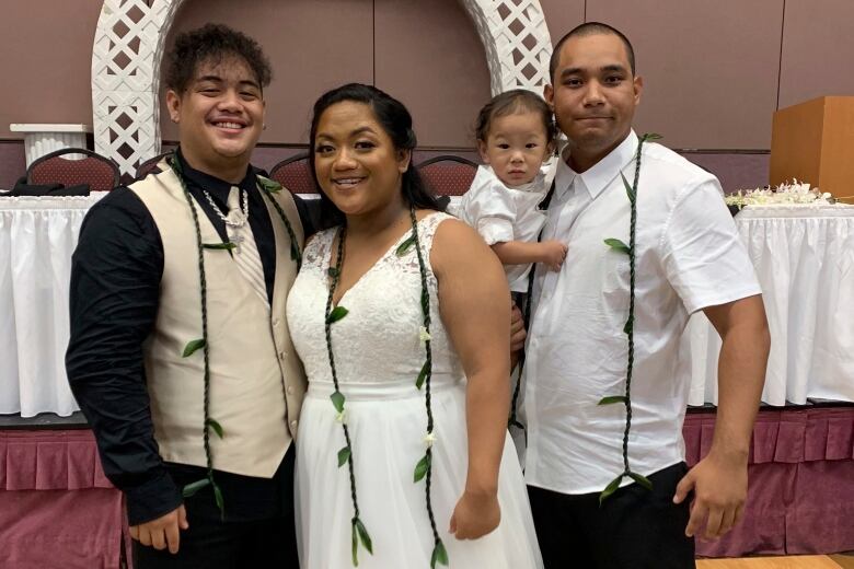 People pose for a photo at a wedding.