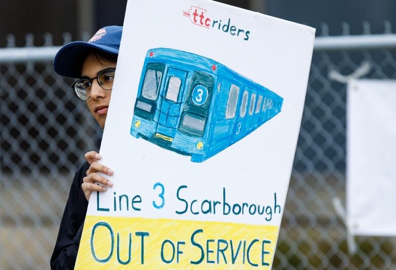 A transit user is photographed in Scarborough, on Aug. 23, 2023. 