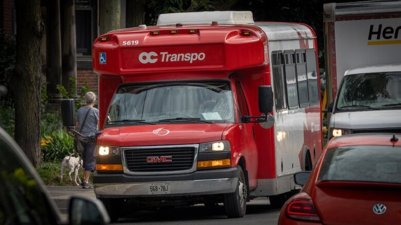 A red and white accessible transit minibus.