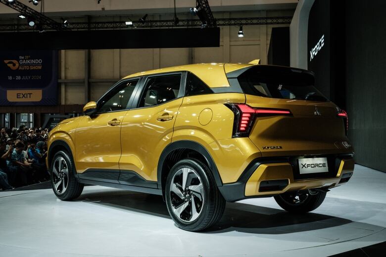 A large gold SUV in a showroom.