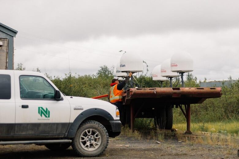 A truck with a worker in the background.