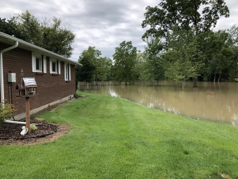 A home with floodwaters very close.