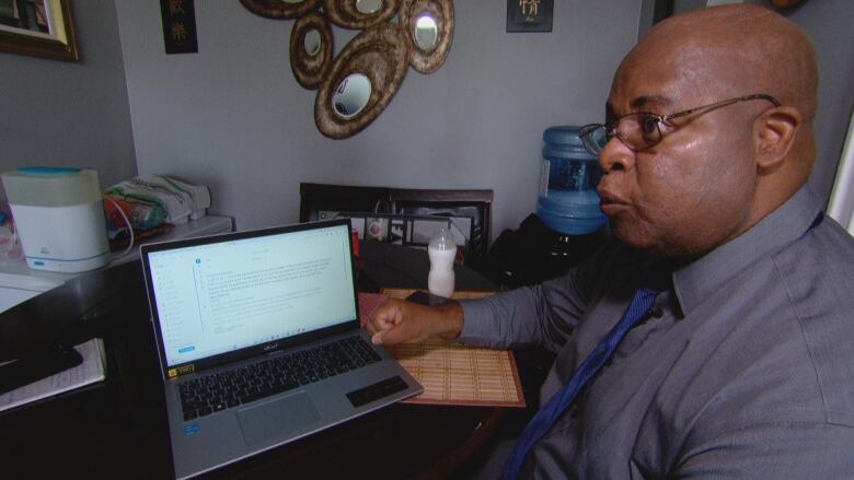 James Mathelier sits at his computer.