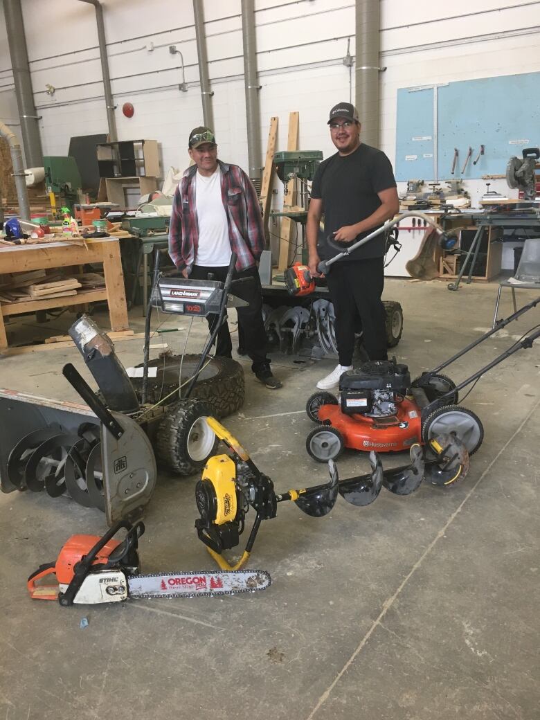 Small Engine Course students Robbie Williams (left) and Elkina Hughie Jr. (right) had less than three weeks of hands-on training to troubleshoot, disassemble and repair heavy duty appliances including chainsaws, ATVs and ice augers.