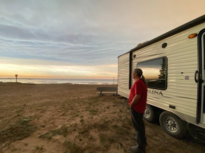 Man outside trailer.