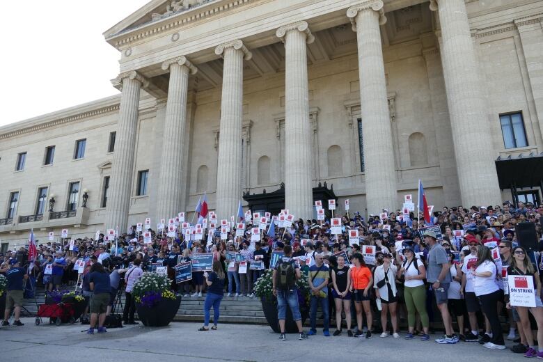 Crowds gather on the steps of a government legislature as part of an ongoing strike.