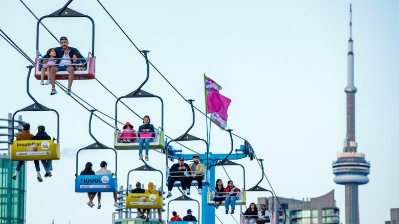 Fairgoers are pictured on the midway on the first day of the CNE, in Toronto, on Aug. 18, 2023.