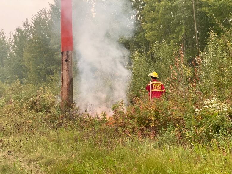 A firefighter deals with a hotspot in the N.W.T.