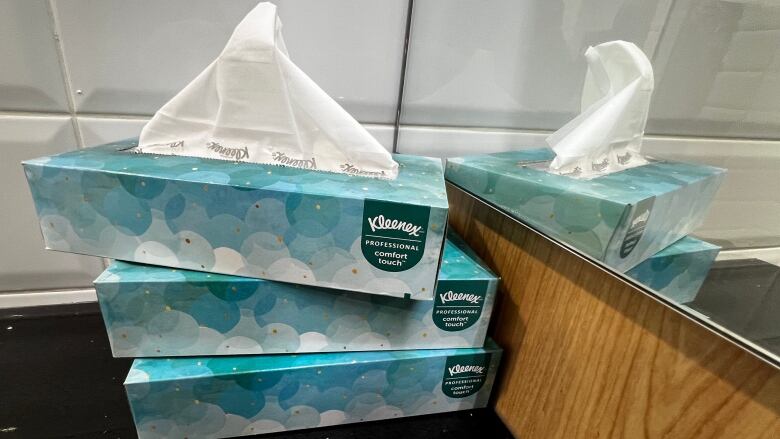 Tissue boxes marked with the words 'Kleenex'.