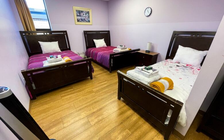 A bedroom furnished with beds, sheets, fresh towels and toiletries in London's Cross Cultural Learning Centre. Newcomers stay at the cultural centre for as long as 5-weeks when they first arrive in London. 