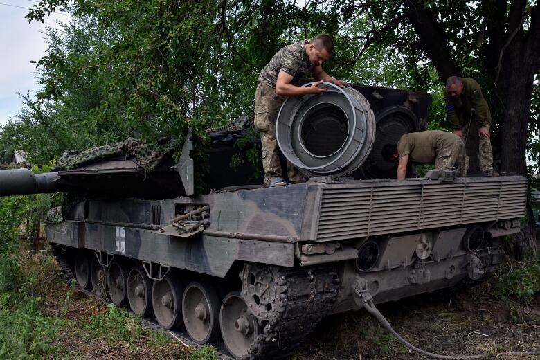 Ukrainian soldiers repair a Leopard 2 tank in Zaporizhzhya region, Ukraine on June 21, 2023.