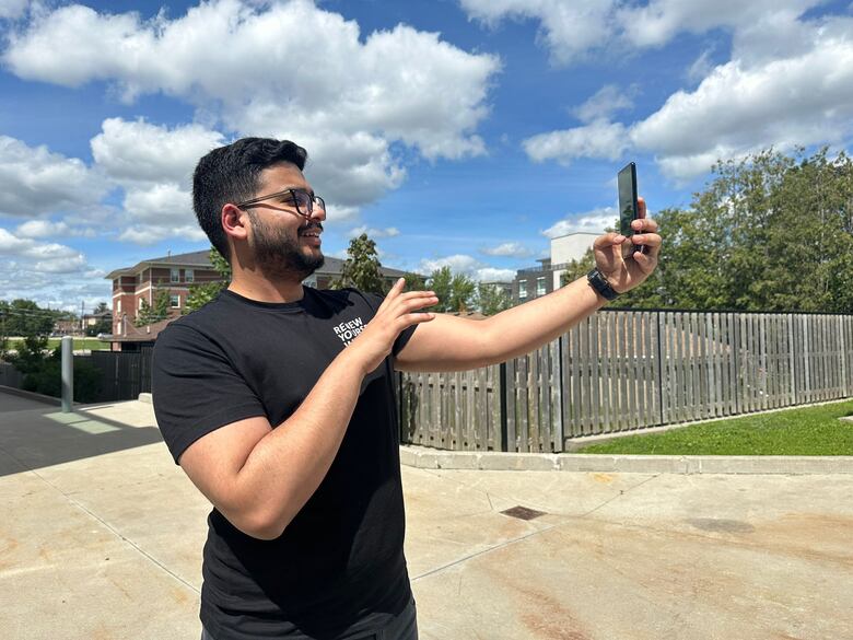 Picture of international student pointing finger to a camera. 