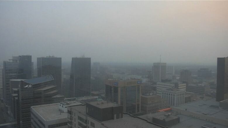 Tall buildings in Regina's downtown are slightly less visible due to a haze blanketing the air and sky over the city.