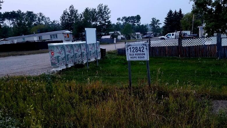 A sign marking 12842 Old Hudson Hope Road, next to some post boxes.