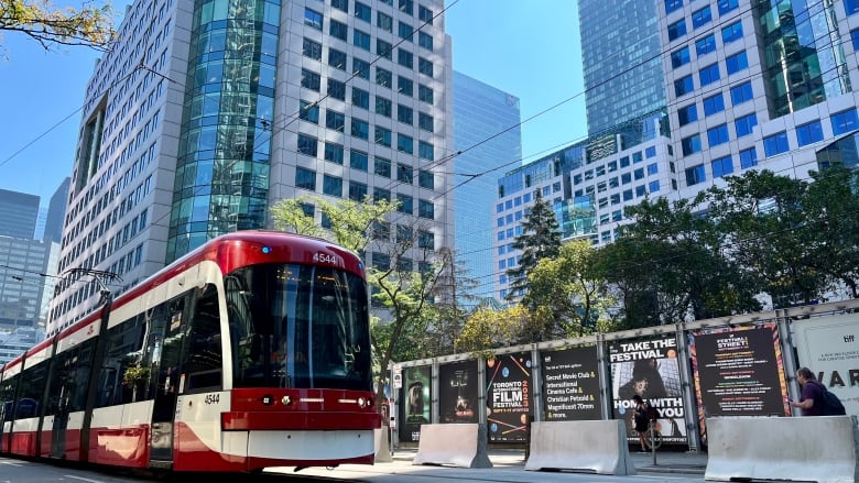 A streetcar drives through King Street where TIFF preparations are underway.