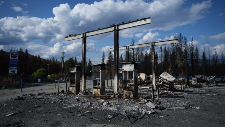 A charred gas station whose fill-up stations have all been razed.