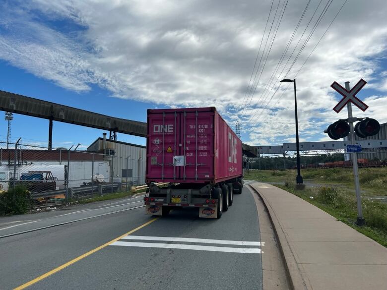 A transport truck drives past a railway crossing on Marginal Road in Halifax.